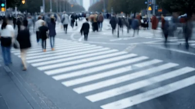 Crowd Of People Walking Across A City Crosswalk