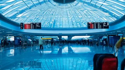 Busy Airport Terminal Hall With Travelers Walking