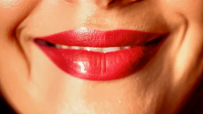 Close Up Of Woman Smiling With Red Lipstick