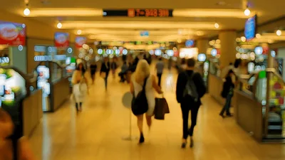 Blurred Commuters Walking Through A Busy Shopping Mall