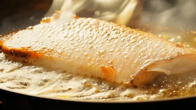 Golden Brown Fish Fillet Searing in Hot Pan
