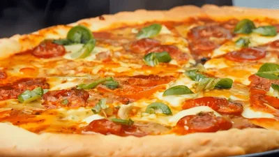 Steaming Hot Pepperoni Pizza With Fresh Basil Leaves