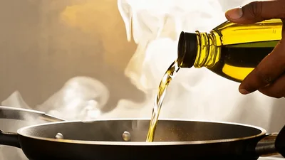 Pouring Olive Oil Into A Hot Frying Pan