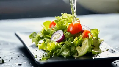 Dressing Being Poured Over Fresh Garden Salad