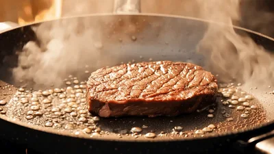 Raw Beef Steak Searing In A Hot Frying Pan