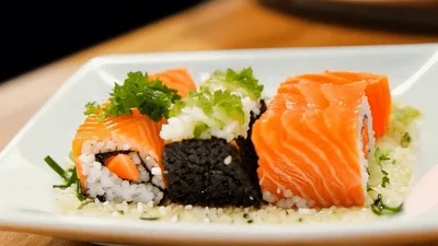 Assorted Salmon Sushi Rolls Served On A White Plate