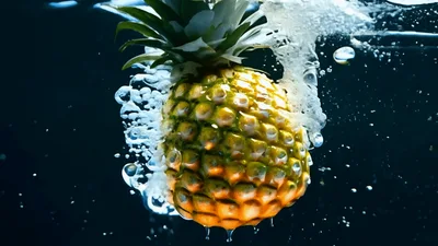 Pineapple Falling Into Water With Bubbles