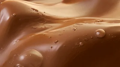 Liquid Milk Chocolate Flowing In Smooth Waves
