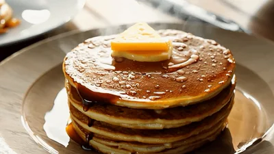 Stack Of Hot Pancakes With Melting Butter And Syrup