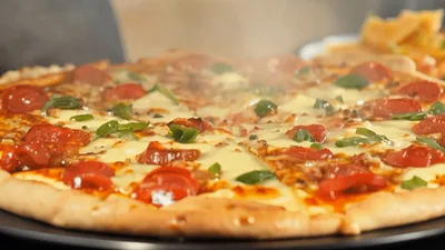 Steaming Hot Pepperoni Pizza on a Black Plate