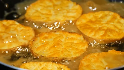 Golden Potato Slices Frying in Hot Oil