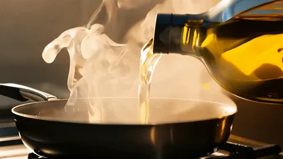 Pouring Olive Oil Into A Hot Frying Pan