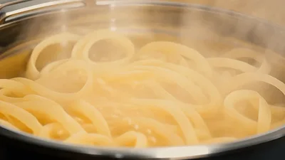 Wooden Spoon Stirring Boiling Pasta In A Pot