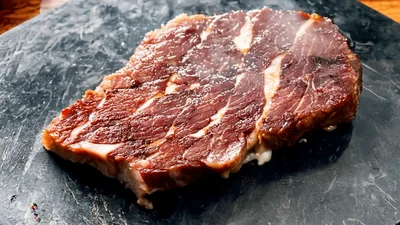 Raw Beef Steak Searing On Hot Stone Plate