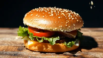 Delicious Cheeseburger Falling Onto A Rustic Wooden Table