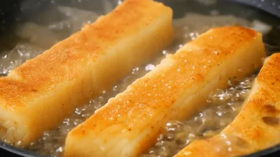Pouring Cream Over Golden Fried Potato Sticks