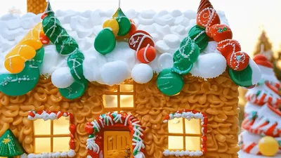 Miniature Gingerbread House With Christmas Decorations In Snow