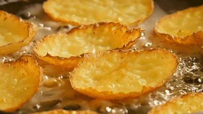 Potato Slices Frying In Hot Oil In A Pan