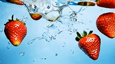 Fresh Strawberries Falling Into Clear Water