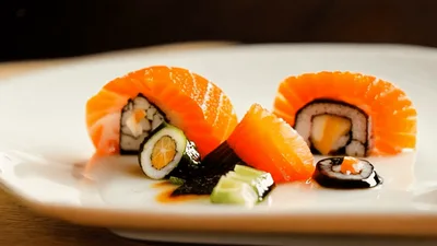 Salmon Sushi Rolls Arranged On A White Plate