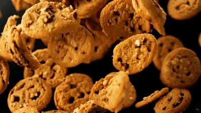 Chocolate Chip Cookies Falling Against Black Background