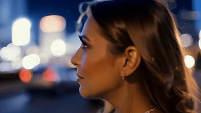 Young Woman Looking At City Lights At Night