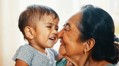 Loving Grandmother Cuddling Her Happy Grandson Indoors