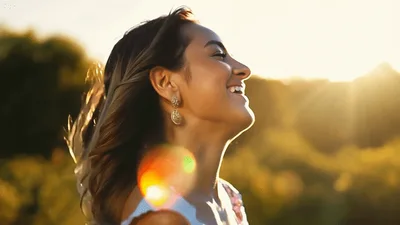 Happy Woman Smiling Outdoors During Golden Hour