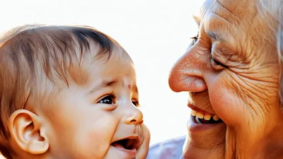 Elderly Woman Smiling And Bonding With Her Baby Grandchild
