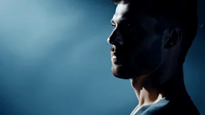Handsome Man Looking Away In Dark Studio Lighting
