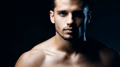 Shirtless Muscular Man Looking Directly Into Camera