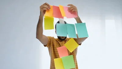 Man Throwing Colorful Sticky Notes Into The Air