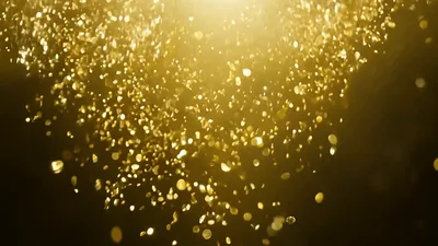 Golden Confetti Falling Against A Dark Background