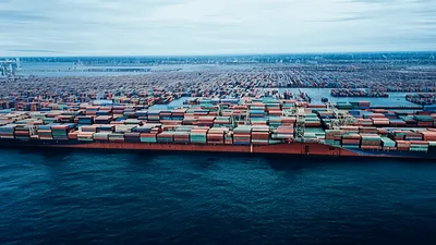 Aerial View Of Large Container Ship Docked At Port