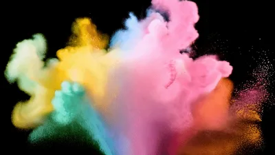 Colorful Powder Explosion Against A Black Background