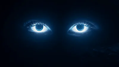 Glowing Human Eyes Opening In Dark Void