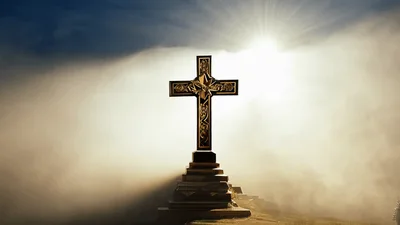 Ornate Golden Cross Standing Amidst Rolling Clouds