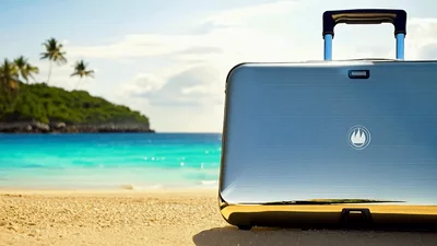 Silver Suitcase Standing On A Tropical Beach
