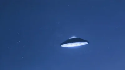 UFO Flying Saucer Descending Through Night Sky