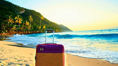 Purple Suitcase Standing On A Tropical Beach At Sunset