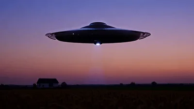 UFO Hovering Over Rural Field Emitting Bright Light Beam