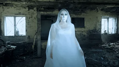 Ghostly Woman In White Dress Walking Through Abandoned Building