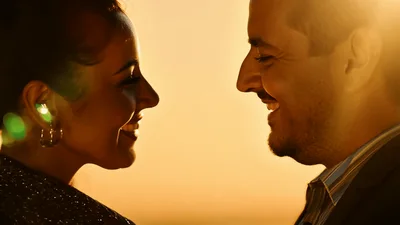 Happy Couple Smiling At Each Other During Golden Hour