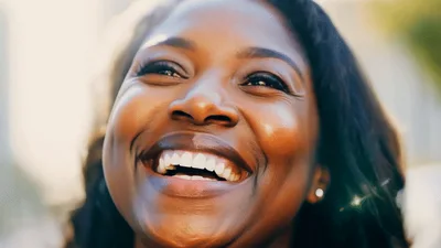 Happy Black Woman Smiling Outdoors In Sunlight