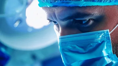 Surgeon Performing Medical Procedure In Operating Room