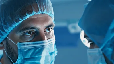 Surgeons Performing Medical Procedure In Operating Room