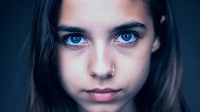 Young Girl With Pierced Nose Staring Intensely At Camera