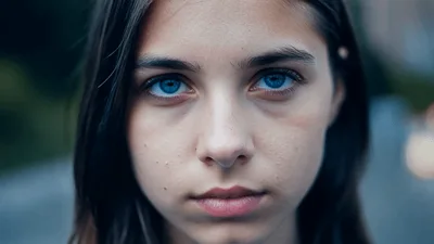 Close Up Portrait Of A Young Girl With Blue Eyes