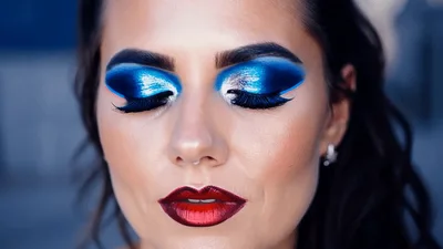 Woman With Dramatic Blue Eyeshadow And Red Lipstick