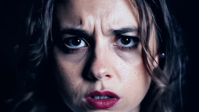 Close Up Portrait Of A Woman With Intense Expression